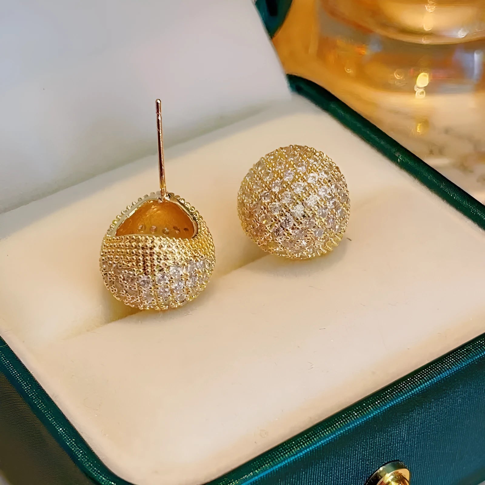 Golden bean earrings with diamond-cut detailing and ear clip fastening in drop shape