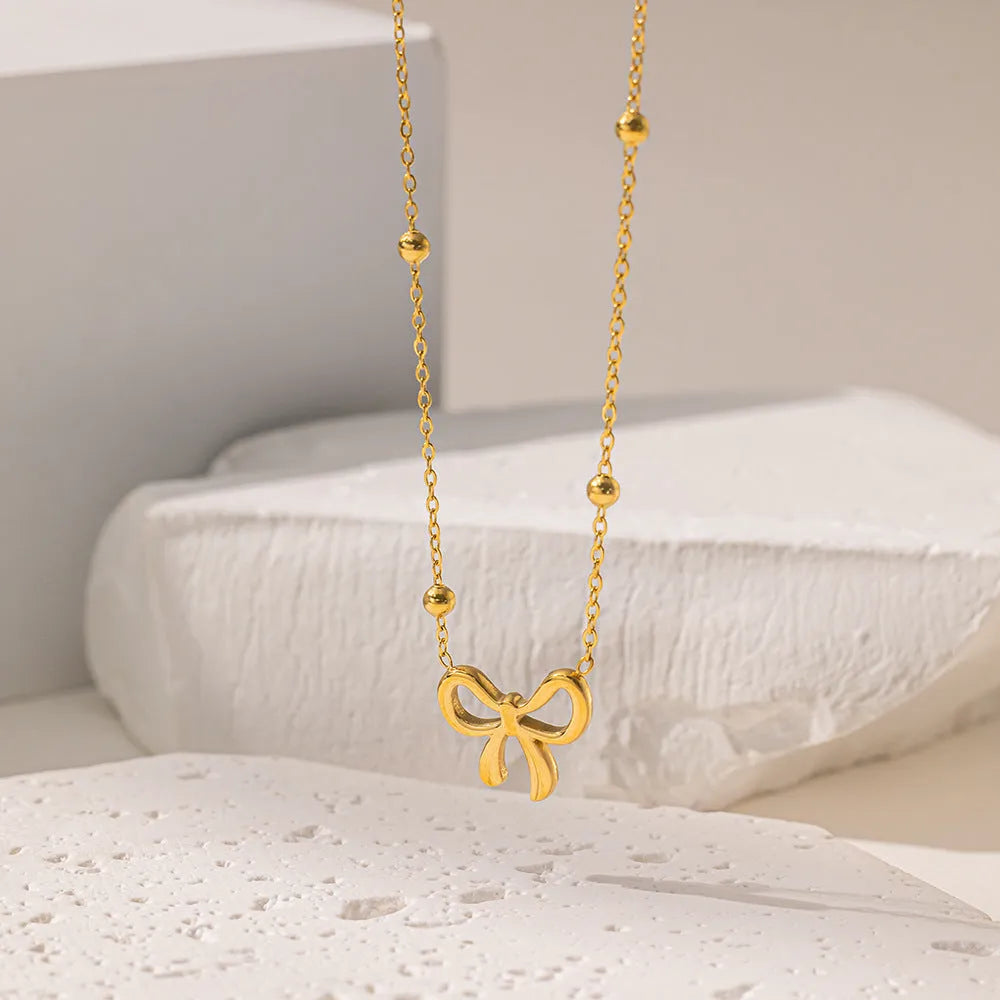 Gold bow necklace on cross chain with 41-50cm perimeter for women's office fashion