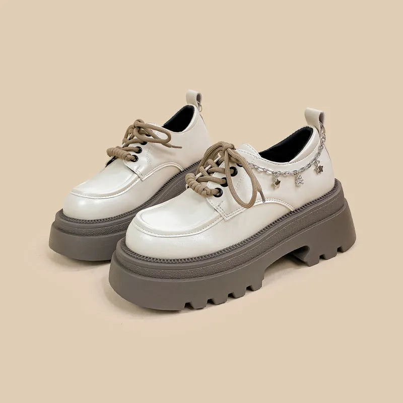 White women's platform leather shoes with lace-up front and a thick chunky heel.