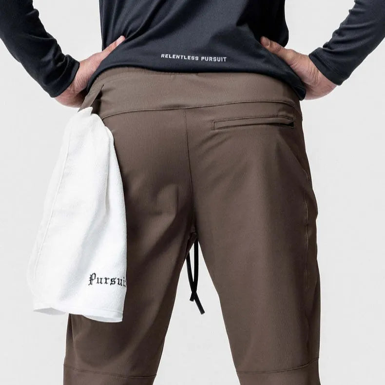 Men's loose grey ankle-tied fitness pants with a casual cut for running and gym workouts.