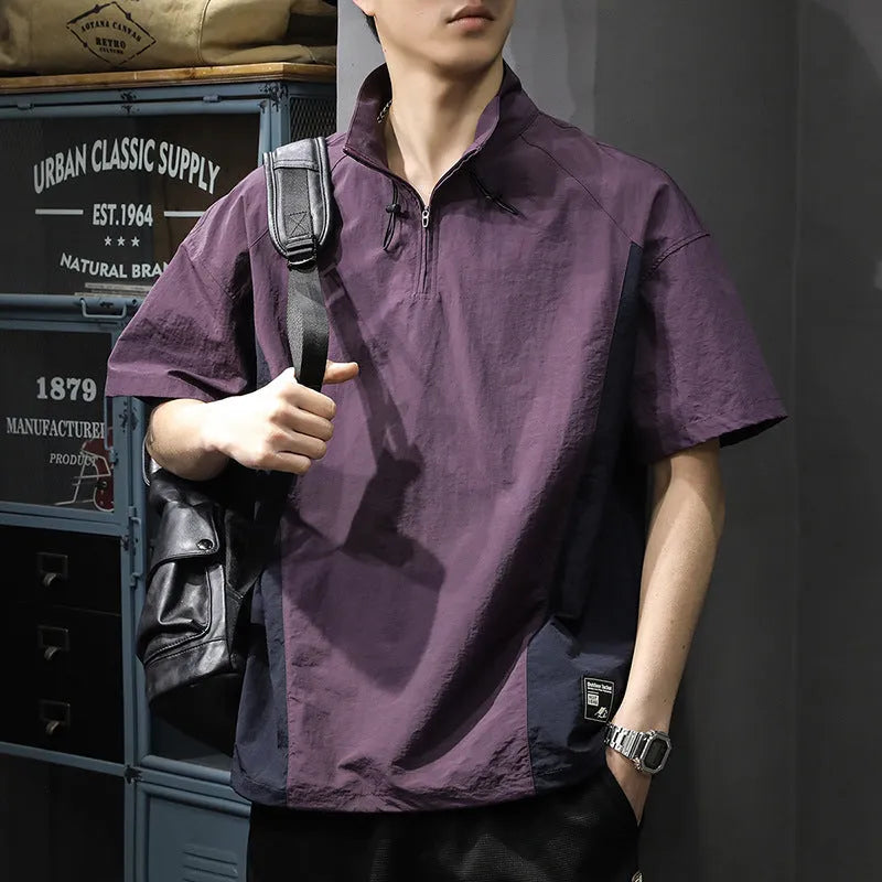 Man modelling a brown half-zip stand collar casual shirt with short sleeves.