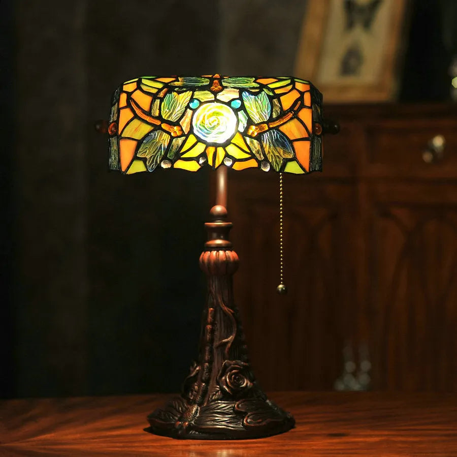 10-inch Tiffany stained glass table lamp on a desk with a warm glow.