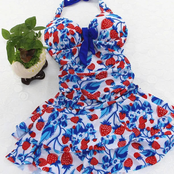 Women's blue strawberry print one-piece swimsuit with cross strap backless design and push-up support.