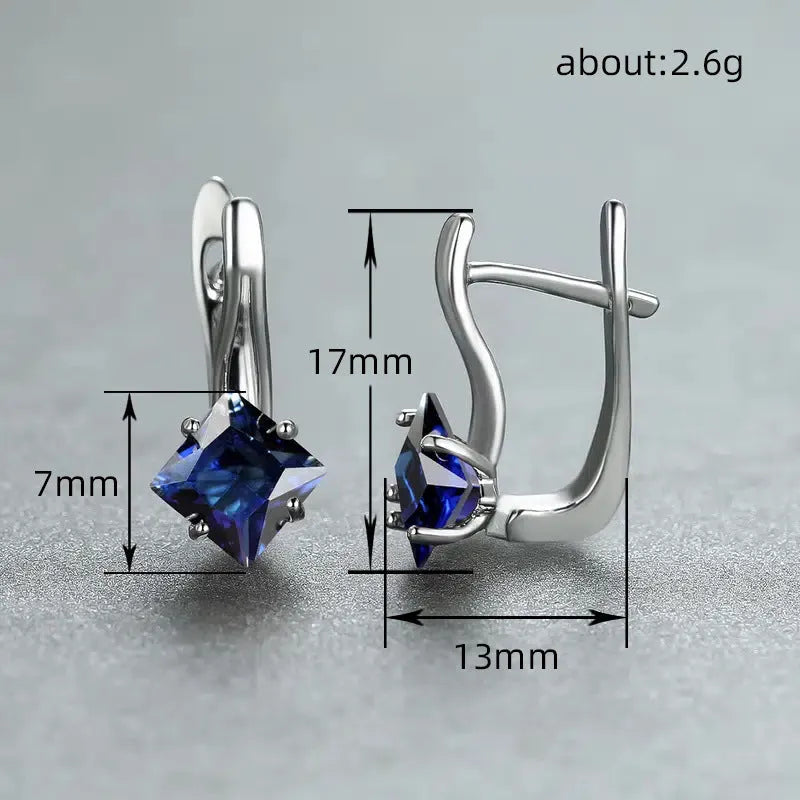 A pair of women's copper earrings with a simple diamond design and inlaid zircon stones, shown in blue.
