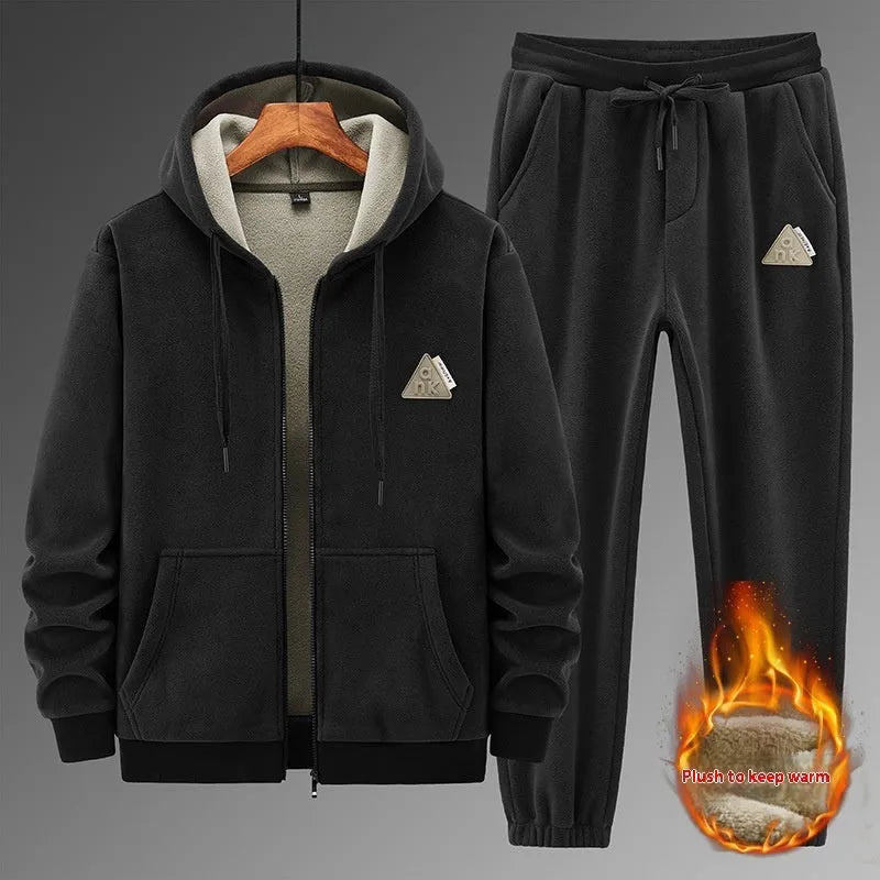 Man wearing a grey cashmere hooded sweater and matching cotton pants from a casual sports suit set.