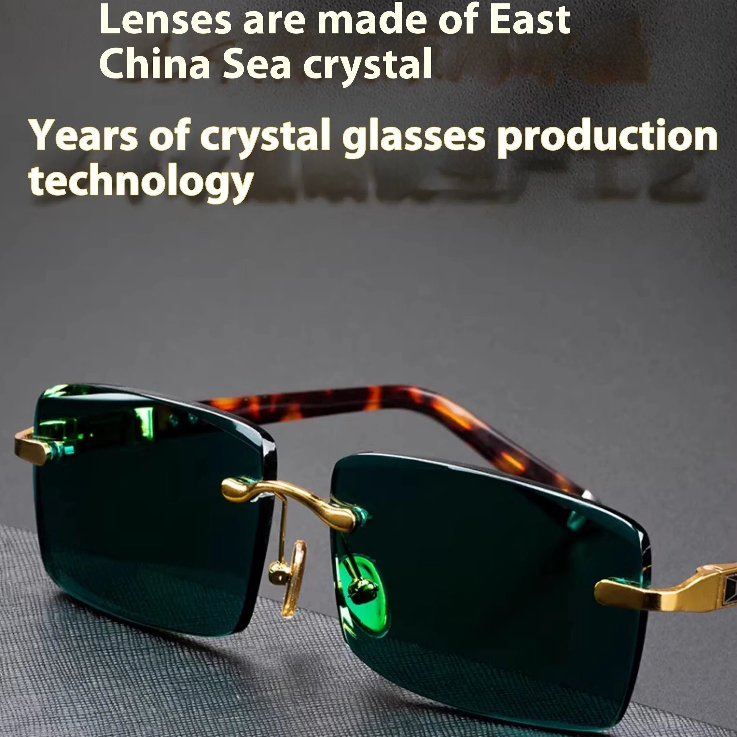 Dark green frameless crystal sunglasses with a hard case and cleaning cloth on a plain background.