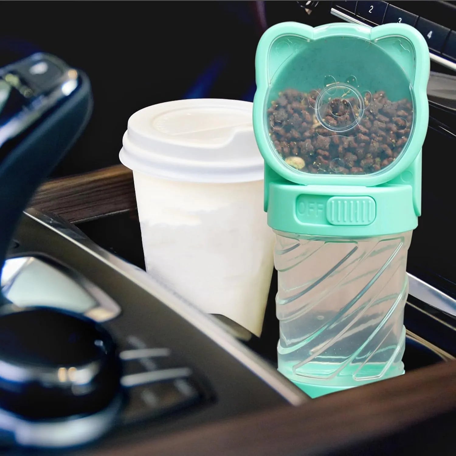 Green 3-in-1 portable pet water bottle with attached bowl, food container, and waste bag dispenser.