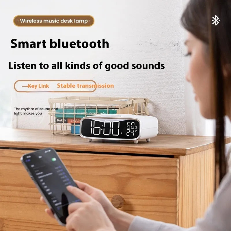White wireless charging Bluetooth speaker with night lamp functions on bedside table