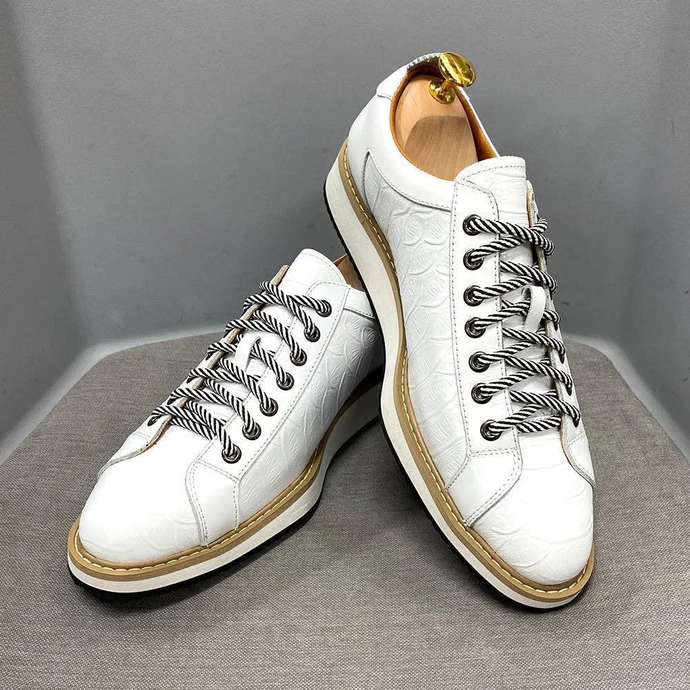 Men's low-top handmade shoes with an embossed pattern and front tie laces.