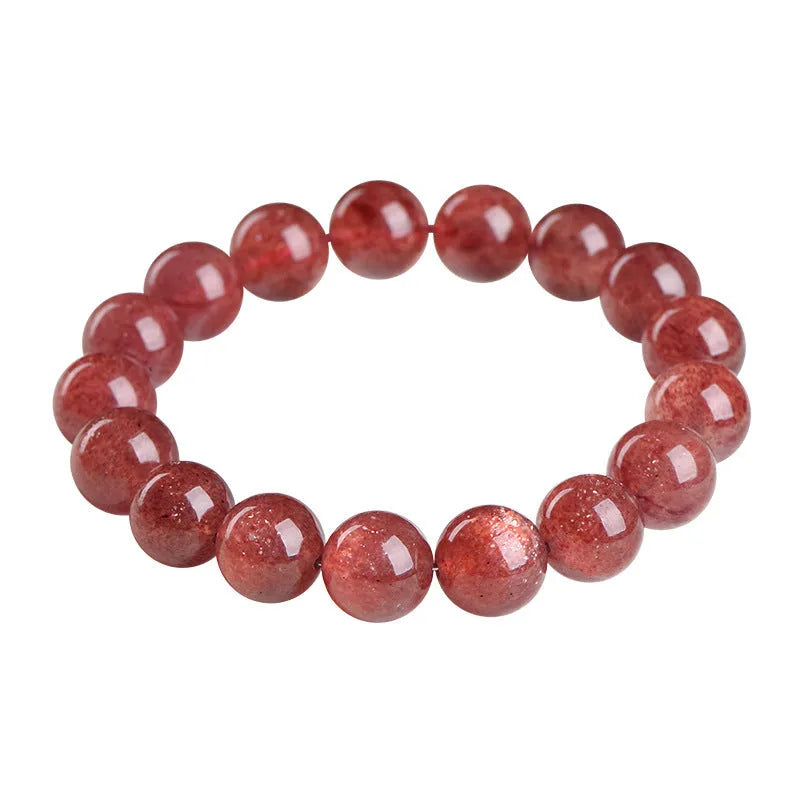 Natural cherry red strawberry quartz bracelet with geometric beads on a wrist
