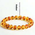 Natural yellow piebald amber geometric bracelet on a white background.