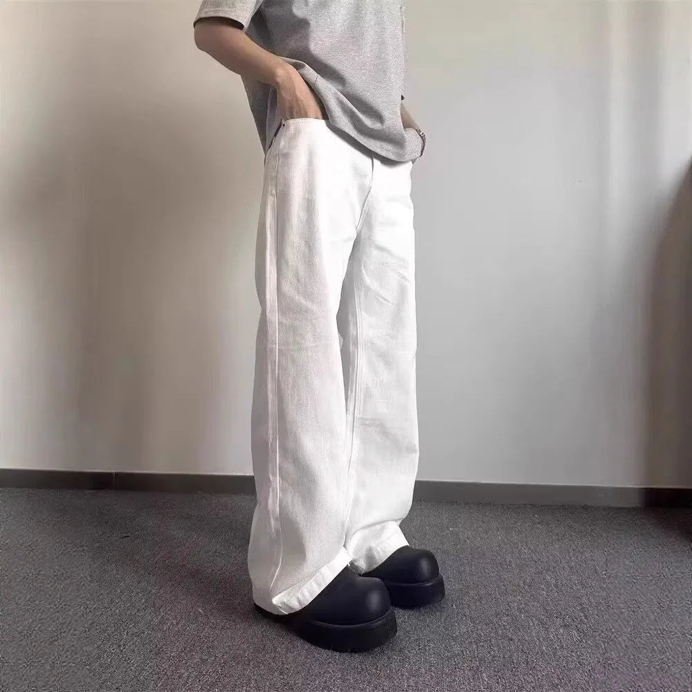 Men's white straight wide-leg denim jeans on a mid waist, showing zipper fly and relaxed fit.