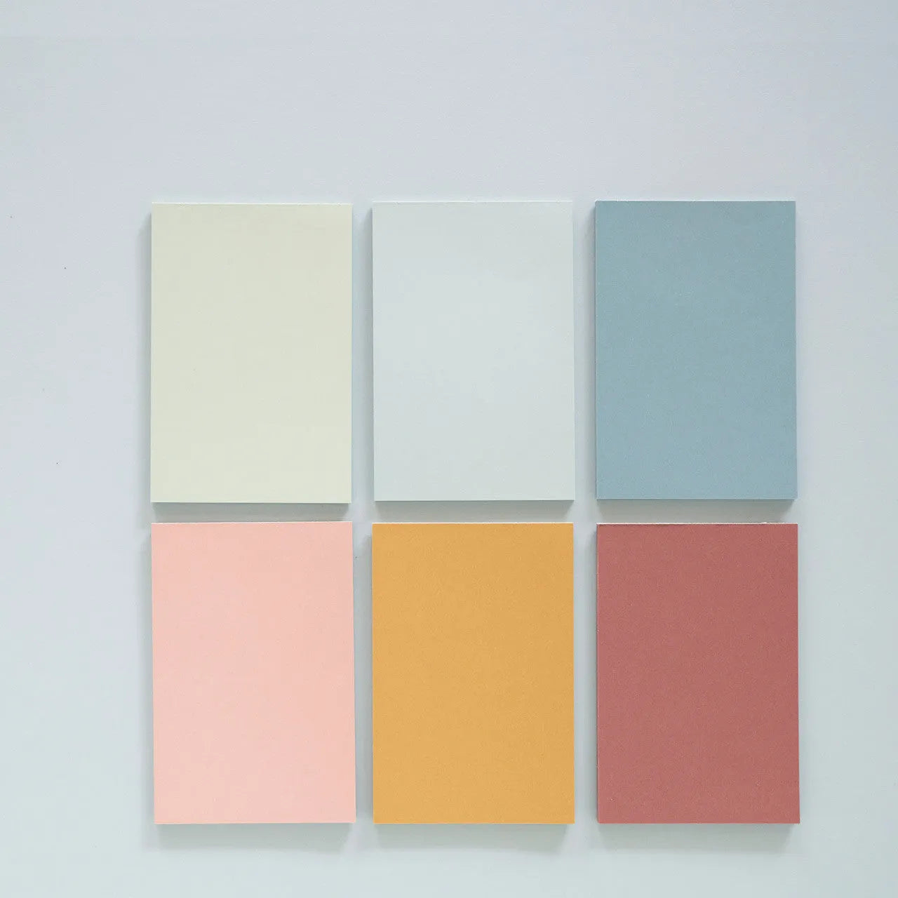 Large self-adhesive sticky notes in six colours measuring 12cm by 8cm, pack of 150 sheets for organisation