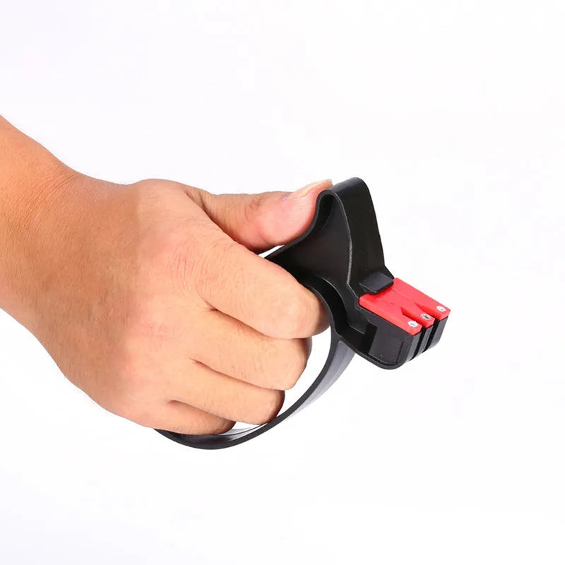 Black handheld knife and scissor sharpener with tungsten steel blade on white background