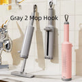Pink rotatable self-squeeze flat mop with microfiber pad extended on a floor.