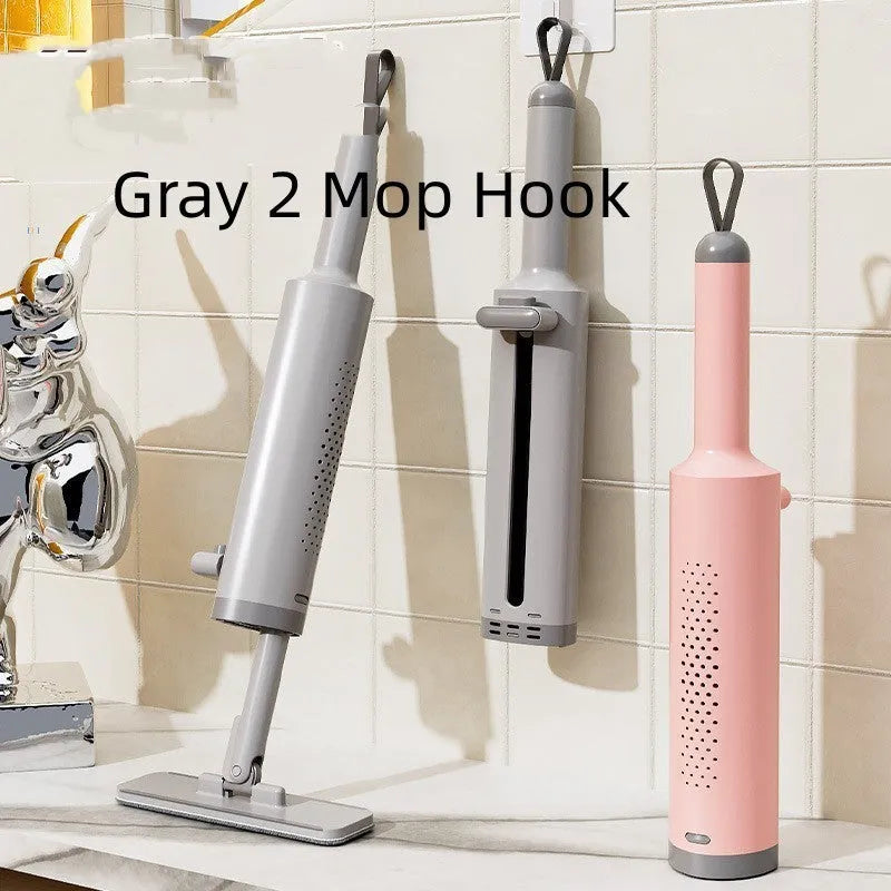 Pink rotatable self-squeeze flat mop with microfiber pad extended on a floor.