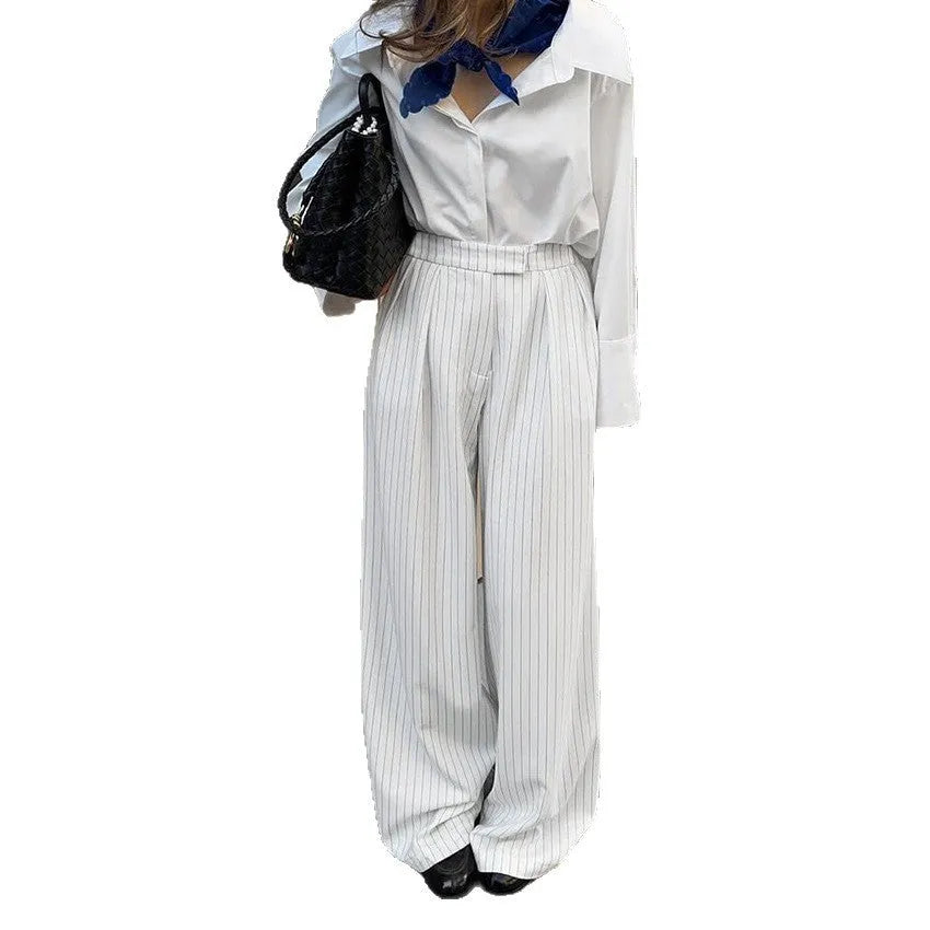 White striped loose fit wide-leg casual trousers with a zipper, shown on a hanger.