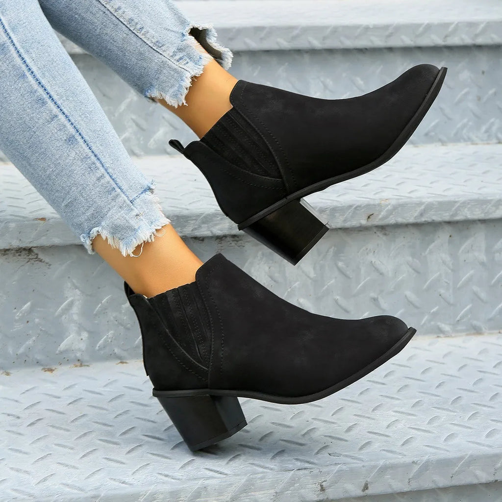 Black women's ankle boot with pointed toe and thick square low heel, slip-on design