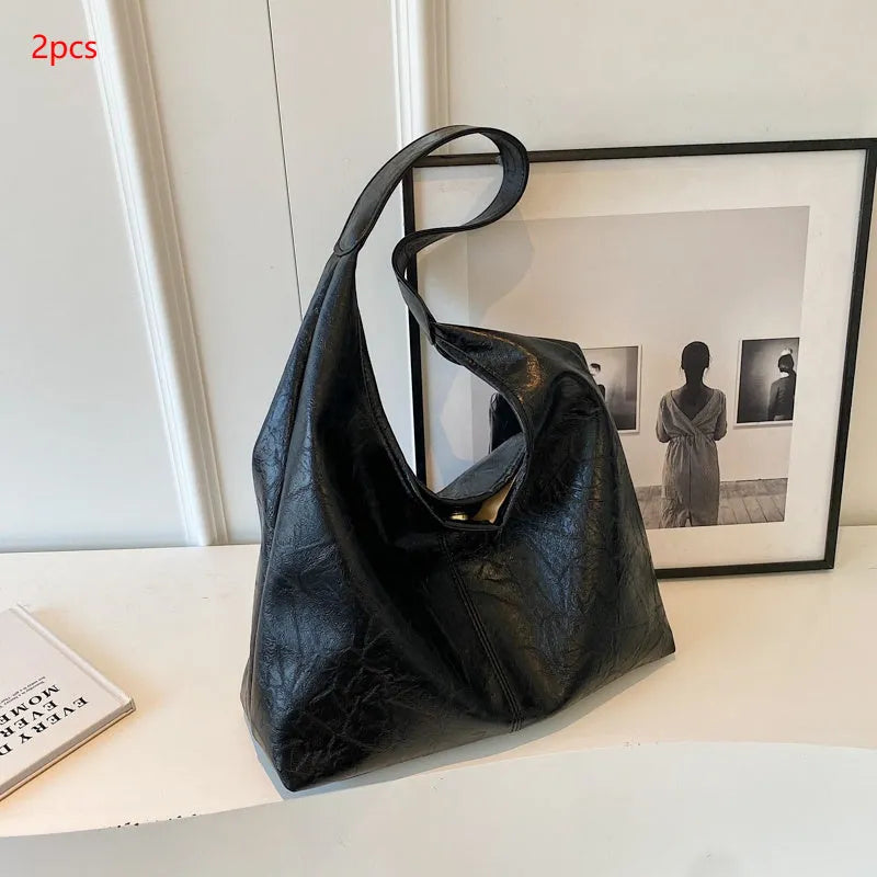Women's casual shoulder bag in soft PU leather with sandwich pocket and visible sewing thread detail