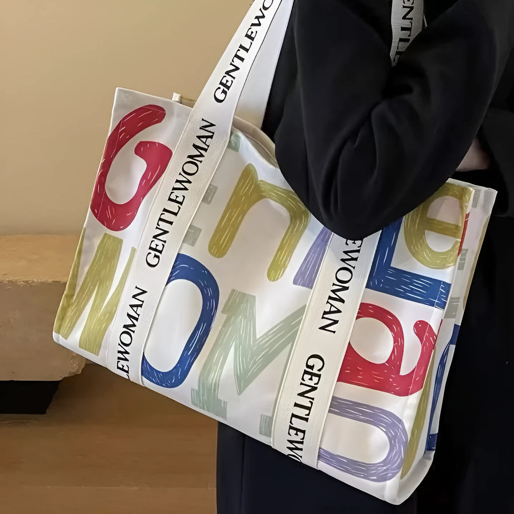 Canvas tote bag with printed design, available in black letters, coloured letters, and pattern style options.