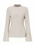 Slim-fit long-sleeve top in black with sunken stripe texture and lantern sleeves on a hanger.
