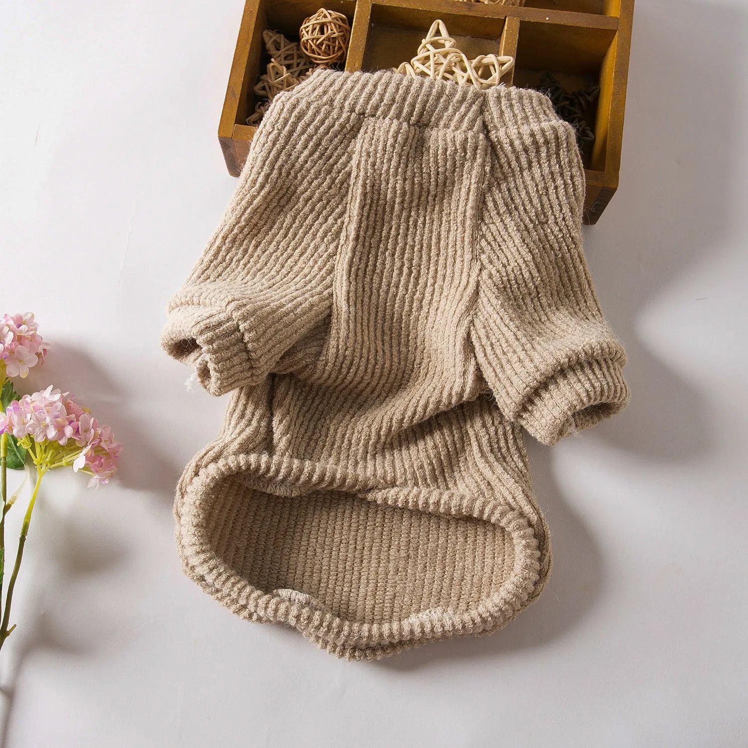 Brown knitted cloth pullover sweater on a small dog, showing casual style.