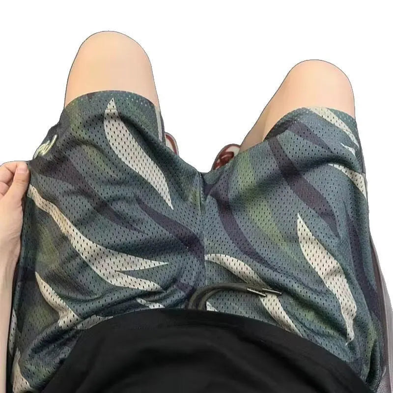 Men's straight-leg camouflage mesh shorts in a cotton-blend fabric laid flat.