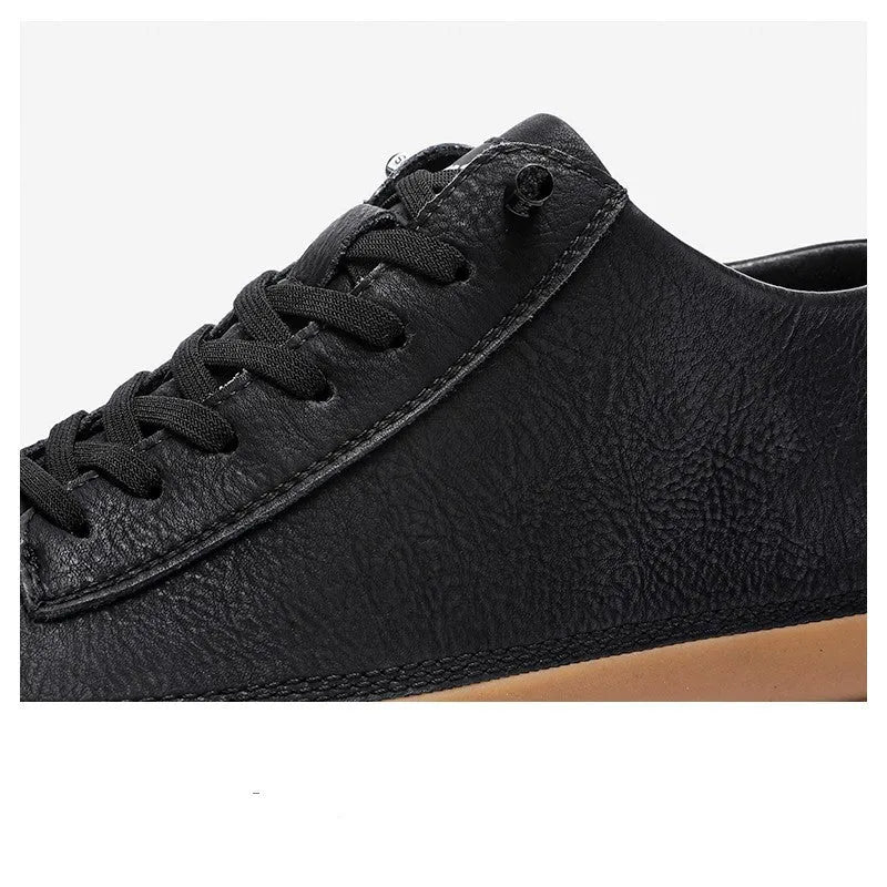 Men's black leather casual shoes with round toe and flat rubber sole on a white background.