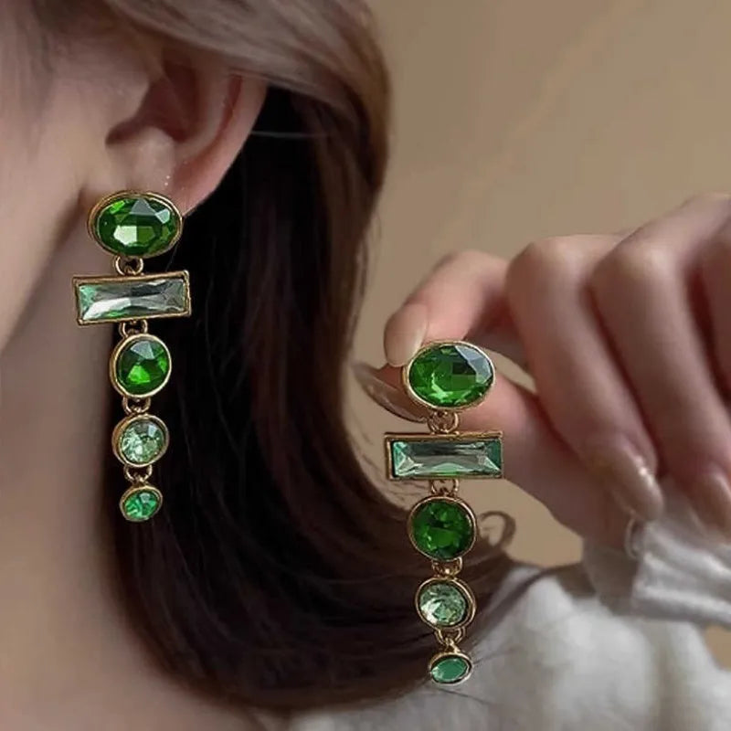 A pair of green gradient tassel earrings with a geometric shape and inlaid zircon detail.
