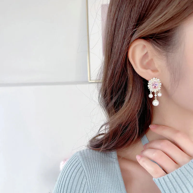 Oval geometric copper earrings with inlaid zircon crystals and pearl tassels in light purple colour