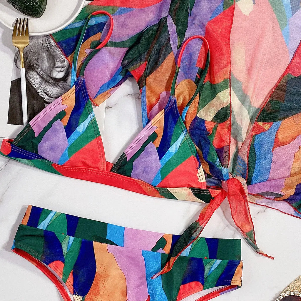 Red printed women's split swimsuit bikini on a mannequin.
