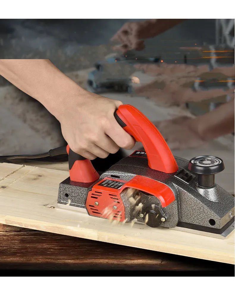 Red desktop electric wood planer with aluminium shell showing 82mm planing width