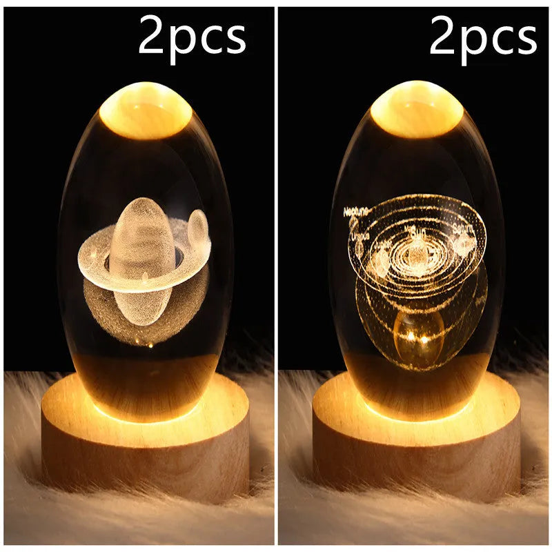 LED galaxy crystal ball night light with 3D planet designs on a table