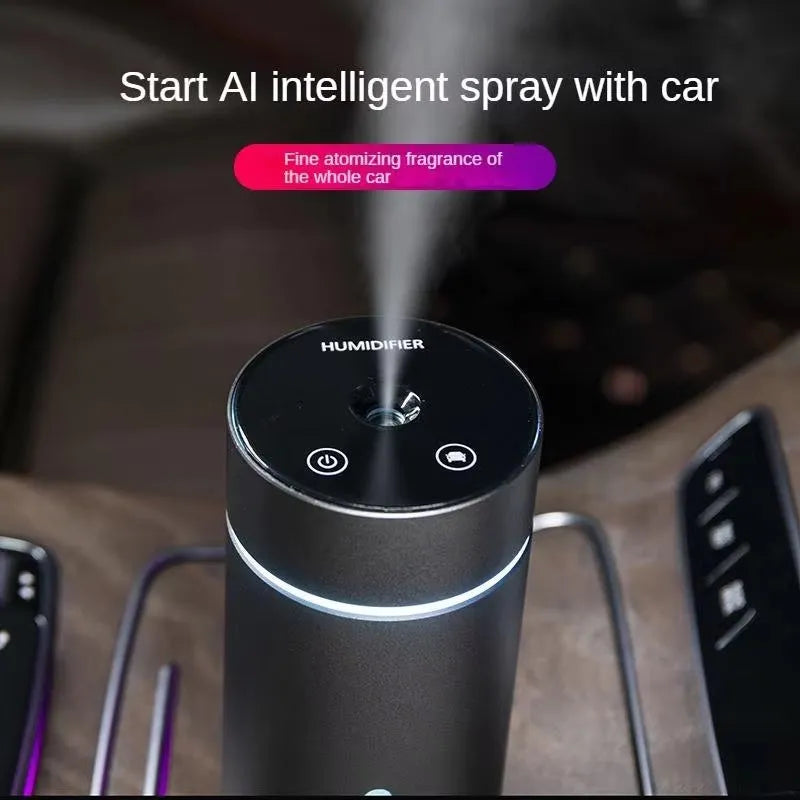 Compact aluminium car humidifier diffuser with colourful light and USB cable on a desk.