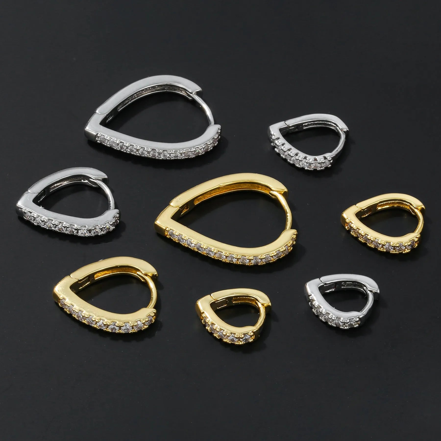 Geometric heart-shaped copper ear clip with electroplated gold finish for women.