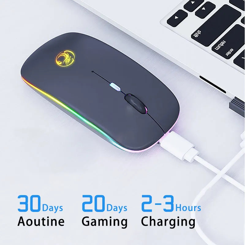 Black and white dual-mode wireless silent mouse with USB charging cable on a desk.