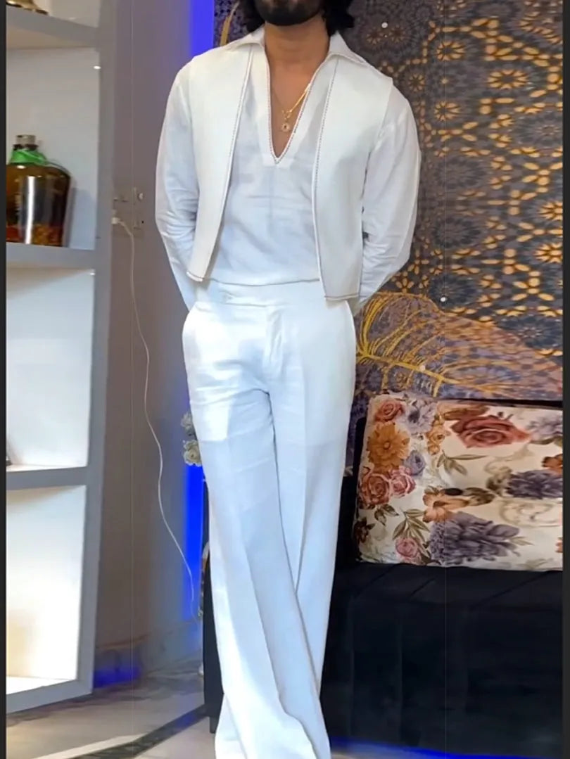 White women's three-piece outfit comprising a V-neck shirt, sleeveless vest, and full-length trousers.
