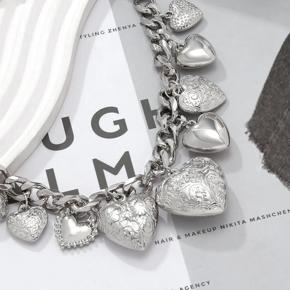 Exaggerated style gold heart pendant necklace with a regular chain on a plain background.