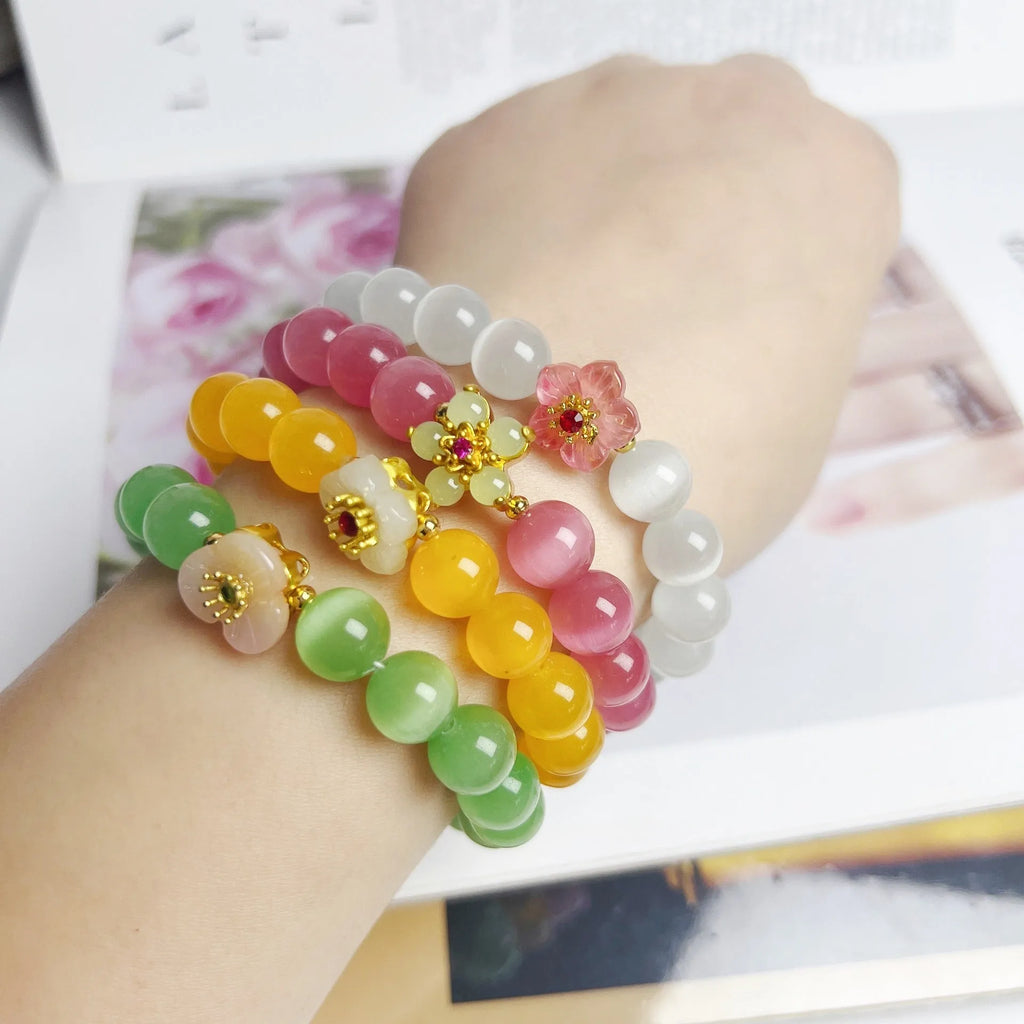Handmade women's glass beaded bracelet with floral elements in yellow, pink, white, or green options