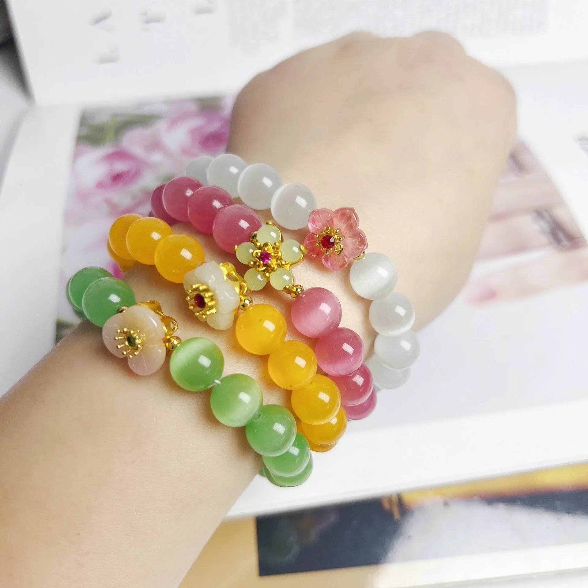 Handmade women's glass beaded bracelet with floral elements in yellow, pink, white, or green options