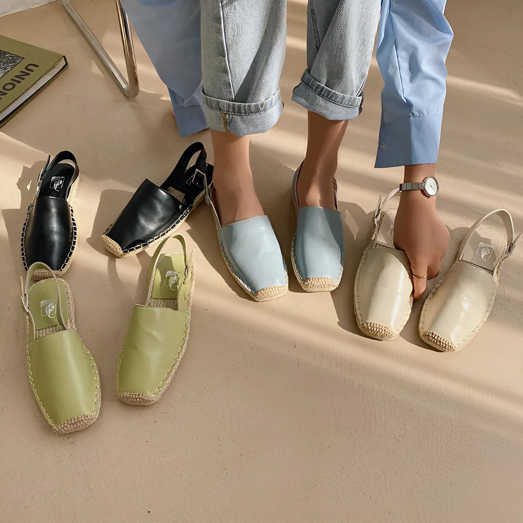 Women's beige canvas fisherman flat sandals with leather trim and animal print, shown on a flat sole.