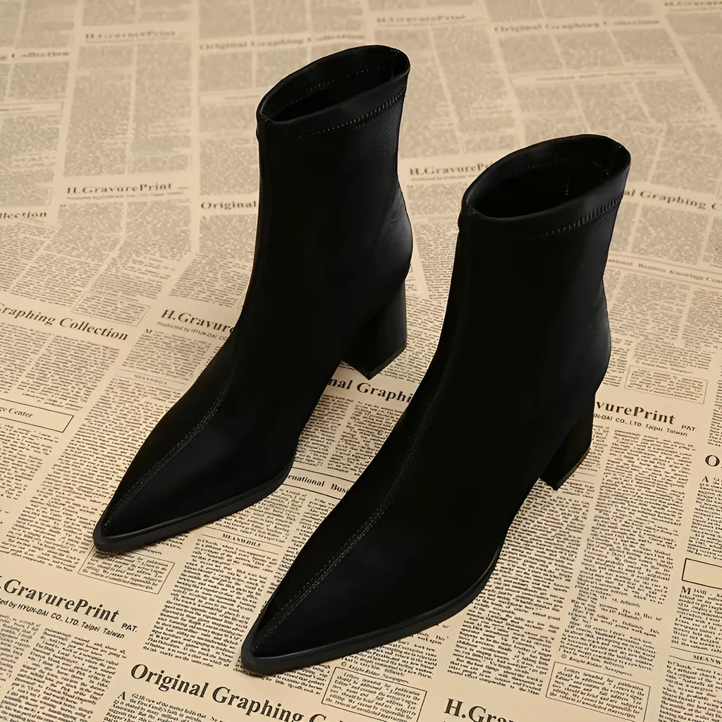 Women's khaki pointed-toe Martin boots with a wedge heel on a plain background.