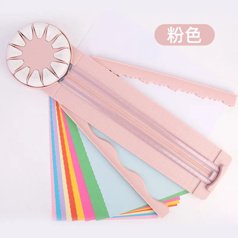 Pink plastic 12-in-1 multifunctional paper cutting machine for crafts on a white background.