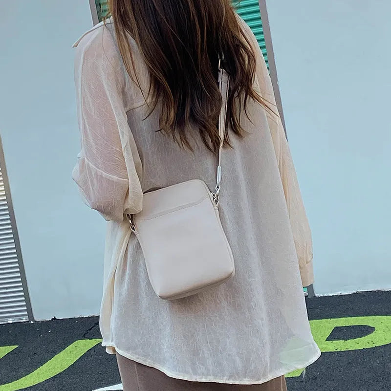 Small solid colour crossbody shoulder bag for women in beige, shown with dimensions.