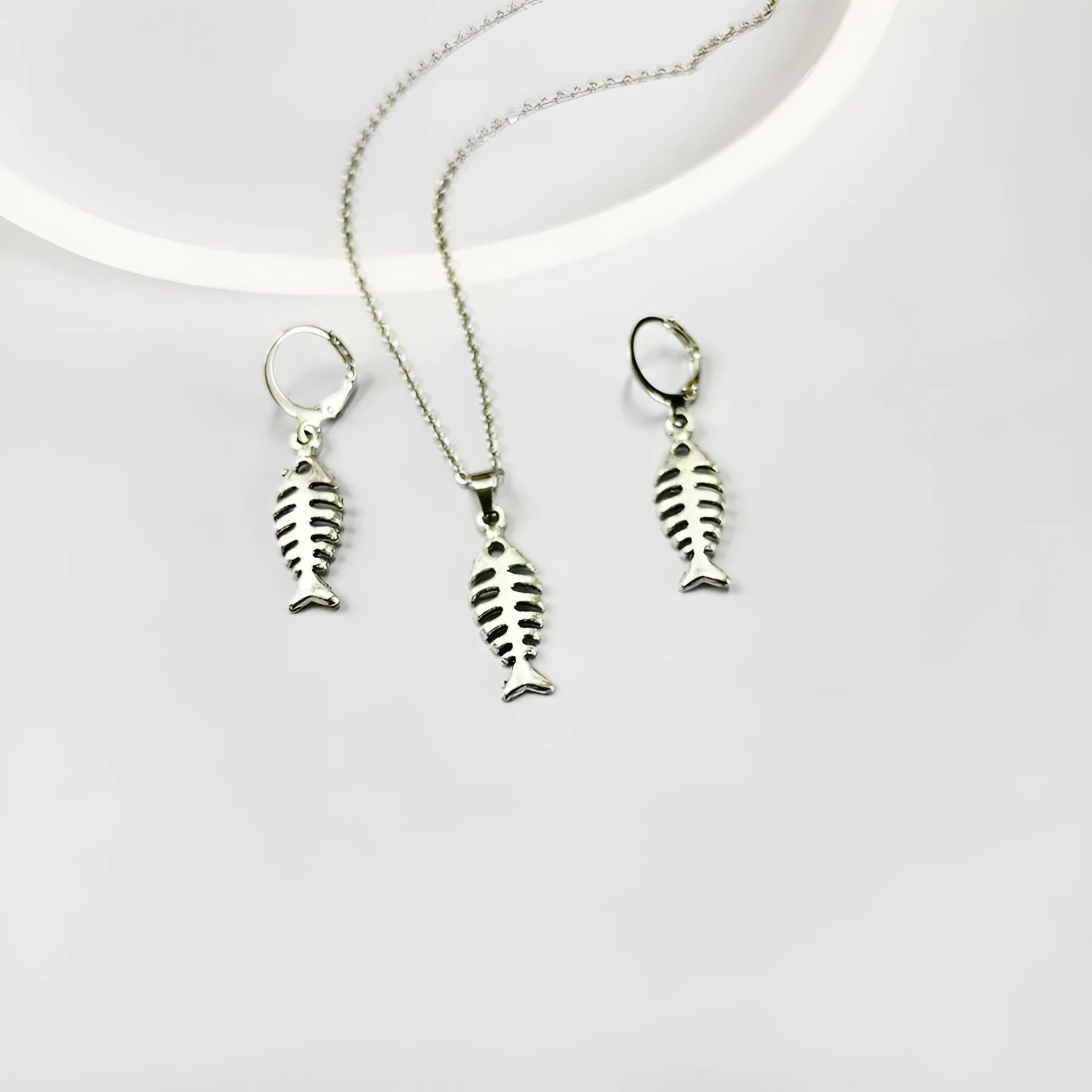 Women's vintage fishbone pendant necklace and matching earrings set with adjustable chain.