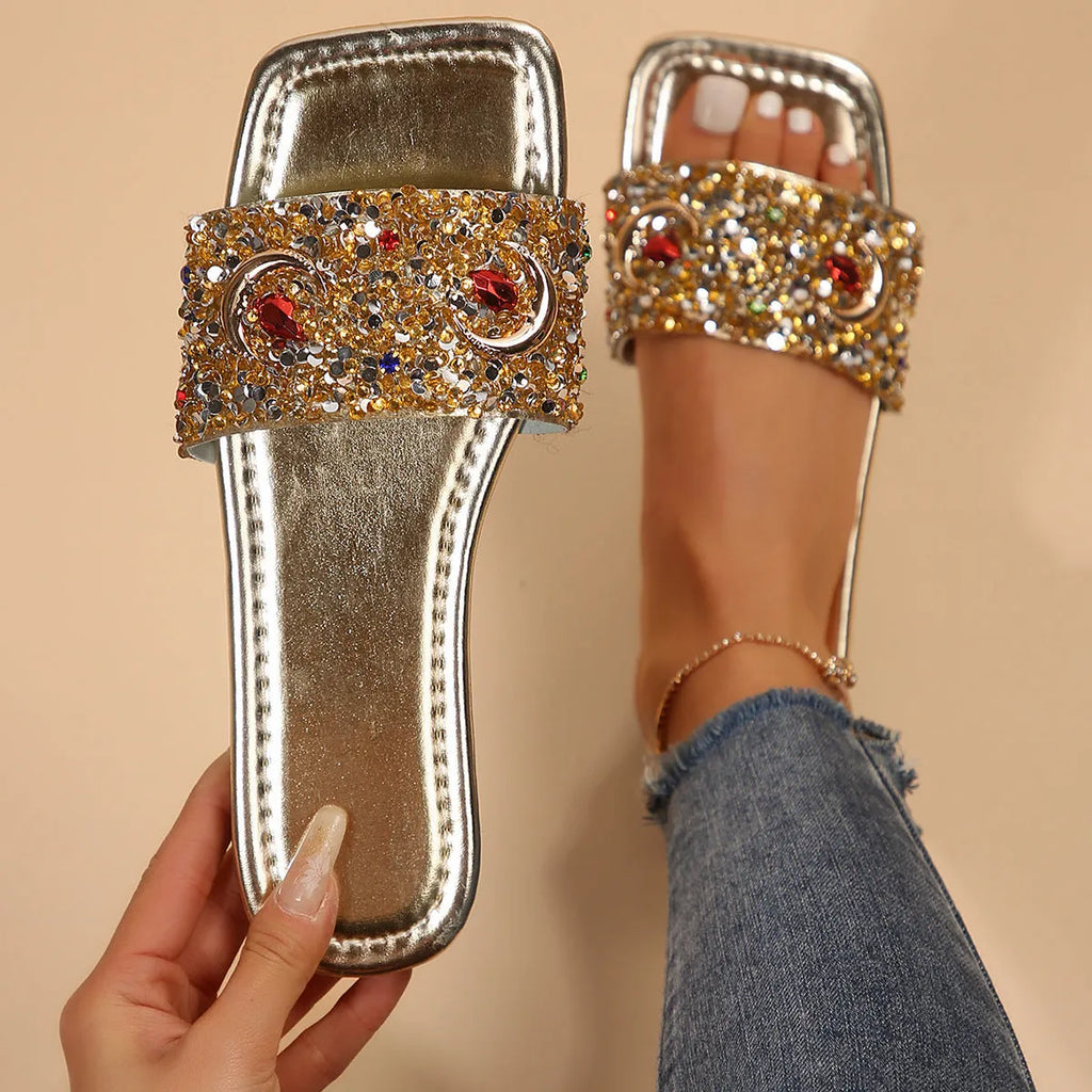 Gold women's slippers with rhinestone sequin detailing on flat rubber soles