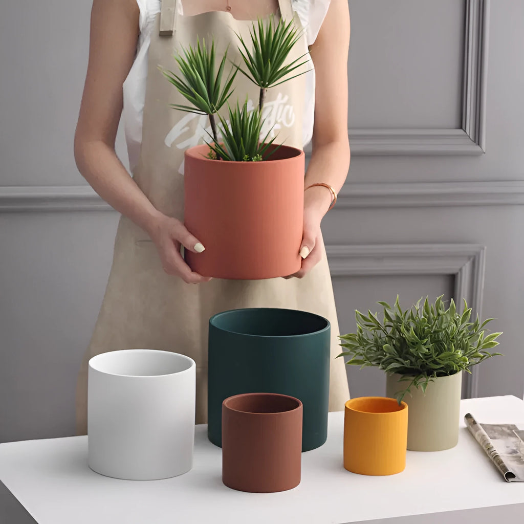 Cylindrical ceramic succulent planter with drainage hole in Nordic style, shown in a selected colour.