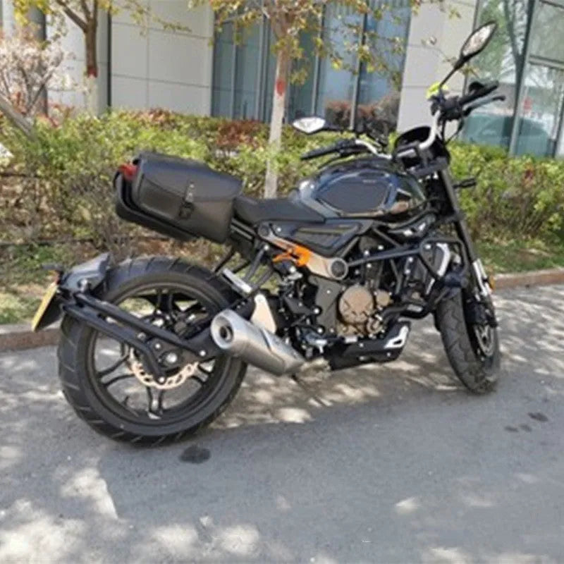 Black motorcycle swingarm saddlebag mounted on a Sportster, showing its size and side-mounting position.