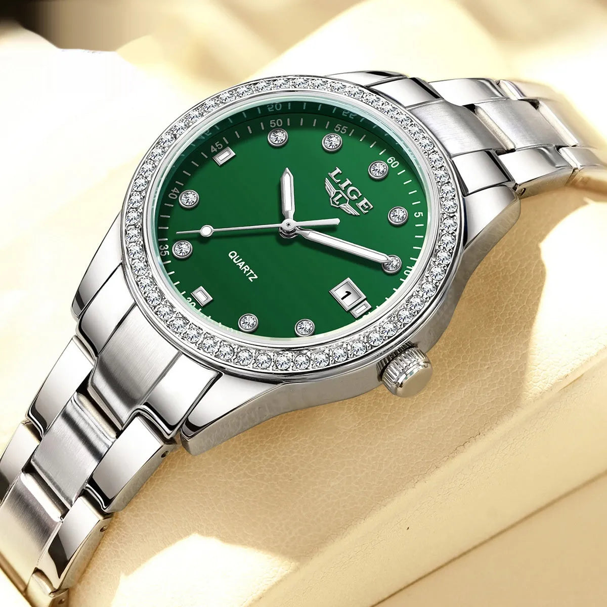 Women's silver fashion watch with diamond bezel, round white dial, luminous hands, and stainless steel bracelet.