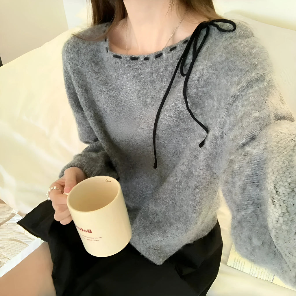 A grey women's loose-fitting pullover knit top made from regenerated cellulose fibre.